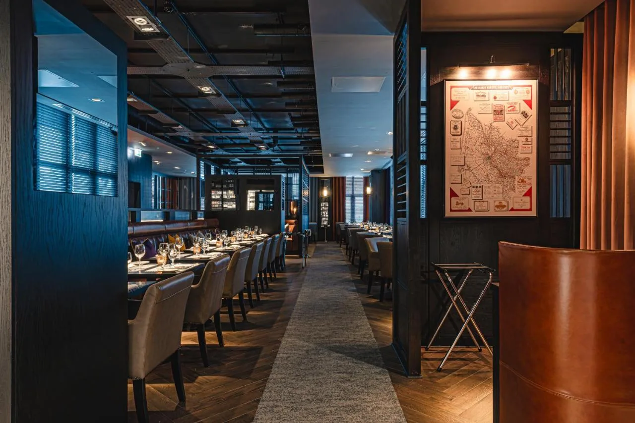 a dining room with long tables and chairs at Dakota Newcastle in Newcastle upon Tyne