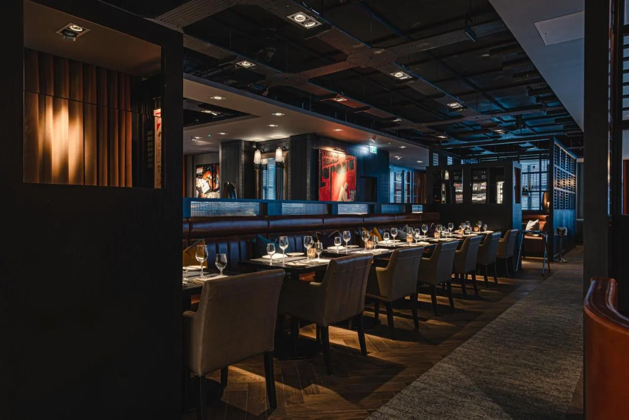 a long dining room with tables and chairs at Dakota Newcastle in Newcastle upon Tyne